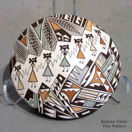 A line of Mimbres dancers and a geometric design on a polychrome seed pot