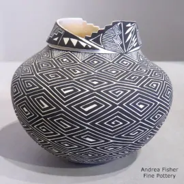 Black-on-white jar with an organic opening and a spiral and geometric design