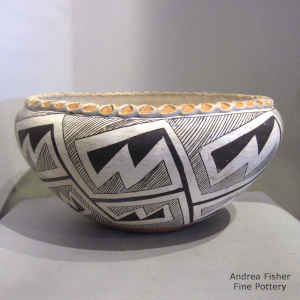 Fine line and locks and keys geometric design on a polychrome bowl with a pie crust rim