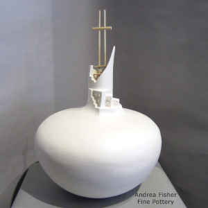 A kiva ladder descends into the cut opening of a pueblo-sculpted white jar