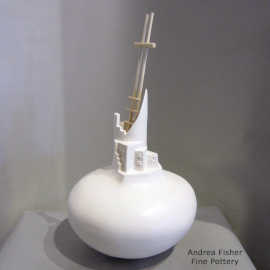 A pueblo-sculpted neck on a white seed pot with a kiva ladder rising out of the opening