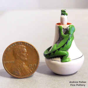 Polychrome miniature jar with a lizard figure eyeing the frog on the lid