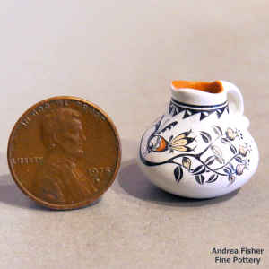 Polychrome miniature pitcher with a bird, branch, flower and geometric design