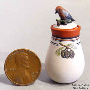 Polychrome miniature jar with a pine cone design with a finch on the lid