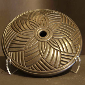 Cherokee star pattern carved into a burnished black disk