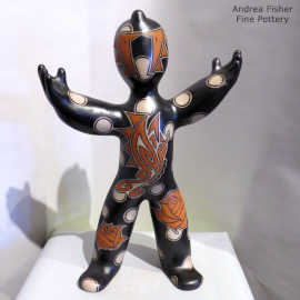 Rose, dot and geometric design on a polychrome standing figure