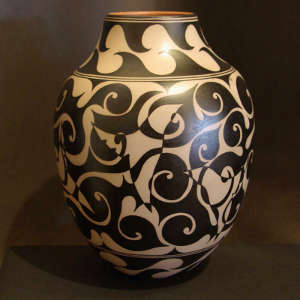 Hummingbird and geometric designs in a negative/positive pattern on a black and white jar