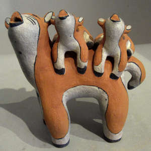 Two children on a polychrome coyote storyteller