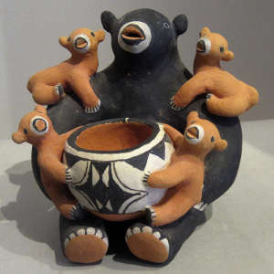 Four children and a pot on a bear storyteller