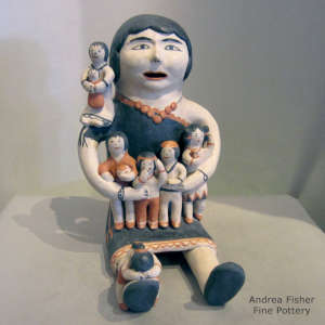 Seven children on a seated grandmother storyteller