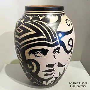 Human faces and geometric design in black-on-white on a polychrome jar