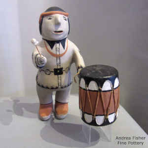 Wood and leather drum attached to a standing drummer figure