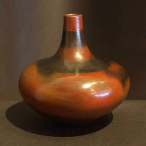 Two black rings and fire clouds decorate a small base brown jar