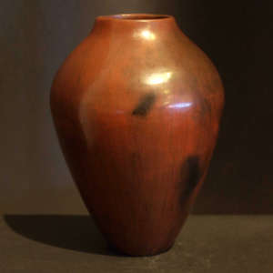 Fire clouds and pine pitch coating on a brown vase