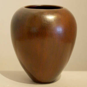 Black fire clouds on a plain brown jar