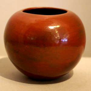 Fire clouds and pine pitch coating on a plain brown jar