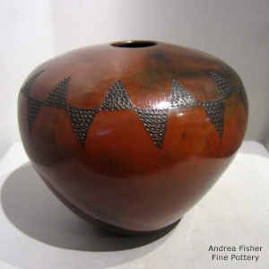 A band of corrugated geometric design on the shoulder of a brown jar with fire clouds