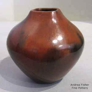 A brown jar with a squarish opening and fire clouds