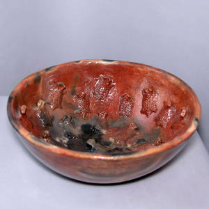 Raised horned toads and fire clouds on a red bowl