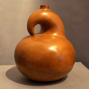 A band of fine line sgraffito decorates the neck of a resting bird sculptural piece