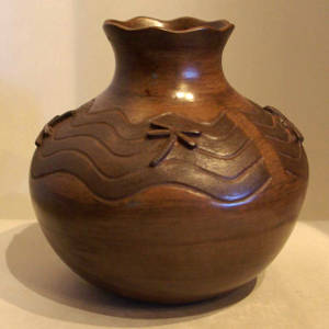 Dragonfly and water pattern relief on a brown jar