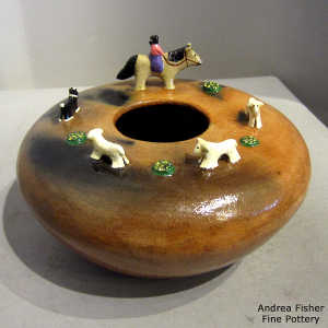 Dineh folk art jar with fire clouds and sheep, dog, horse and woman riding around on upper shoulder