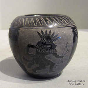 Sgraffito masked dancer and geometric design on a small black and white seed pot