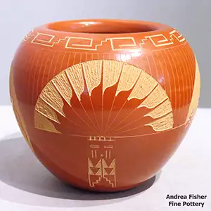 A sgraffito buffalo, dancer and geometric design on a red bowl