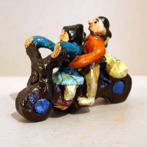 Couple riding a motorcycle with a bag of flour