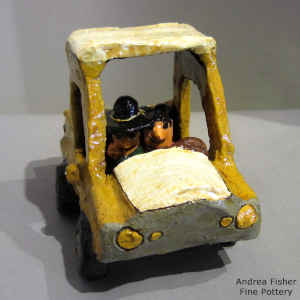 Dineh couple in a pickup with a dog in the back