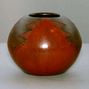 Fire clouds and Dineh rug design on a brown jar