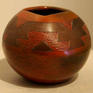 Dineh rug design on a brown jar with a square opening