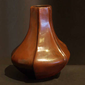 A long neck and vertical ribs on a brown jar