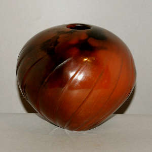 Fire clouds on a spiral-carved brown melon jar