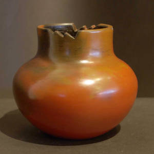 A high neck and a cut rim on a brown jar with fire clouds