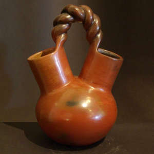 A twisted handle and fire clouds on a brown wedding vase