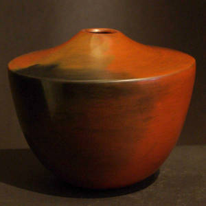 Small mouth and fire clouds on a flat shouldered brown jar