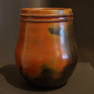 Dual biyos around the neck of a brown jar with fire clouds