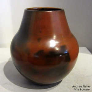 Pine potch coating on a brown jar with black fire clouds