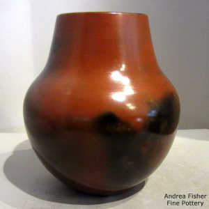 Pine pitch coating on a brown jar with black fire clouds