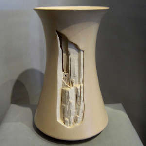 A pueblo motif carved into an architectural piece