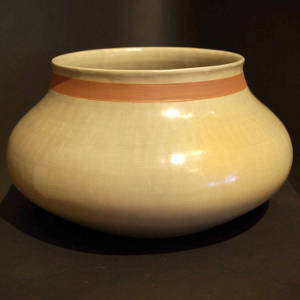 Red band around the neck of a large buff bowl