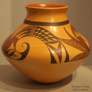 Red and black bird element designs on a yelloware jar