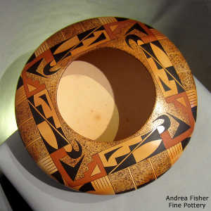 Four direction stylized eagletail and geometric design on a polychrome yellow ware bowl with fire clouds
