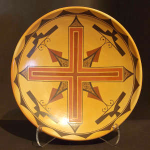 Geometric design inside a shallow polychrome yellow ware bowl