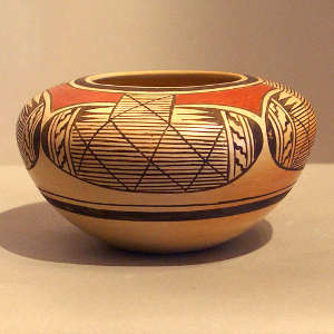 Red and black four direction bat wing pattern and geometric design on a yellowware jar