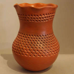 Textured design, polished interior and pie crust rim on a red jar