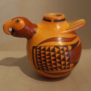 Red and black bird element designs on a yellow ware bird effigy pot