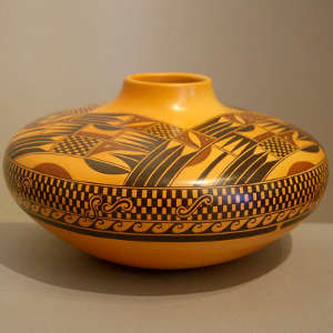 Red and black geometric design on a yellow Sikyatki-style jar