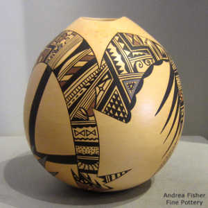 Stylized Sikyatki design on a polychrome yellow ware seed pot